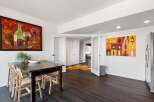 This stunning dining area boasts a dark wood dining table and chairs, perfect for hosting gatherings.
