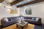 This cozy living space features a stylish sectional sofa, perfect for relaxing and entertaining.