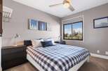 This inviting bedroom features a cozy bed with a stylish blue and white checkered comforter.