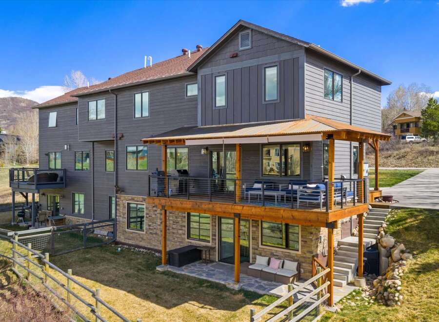 This stunning property boasts a modern design with a spacious deck, perfect for entertaining or relaxing.