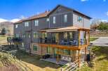 This stunning property boasts a modern design with a spacious deck, perfect for entertaining or relaxing.