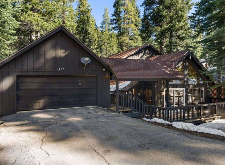 Nestled amidst towering trees, this charming home offers a serene escape.