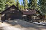 Nestled amidst towering trees, this charming home offers a serene escape.