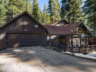 Nestled amidst towering trees, this charming home offers a serene escape.