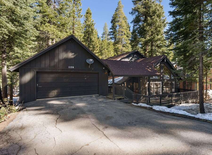 Nestled amidst towering trees, this stunning property offers a serene retreat.