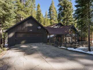 Nestled amidst towering trees, this stunning property offers a serene retreat.