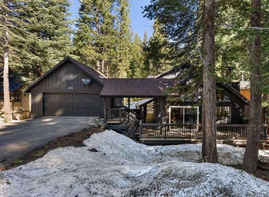 Nestled amidst towering trees, this charming home offers a serene escape.