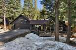 Nestled amidst towering trees, this charming home offers a serene escape.