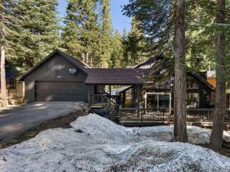 Nestled amidst towering trees, this charming home offers a serene escape.