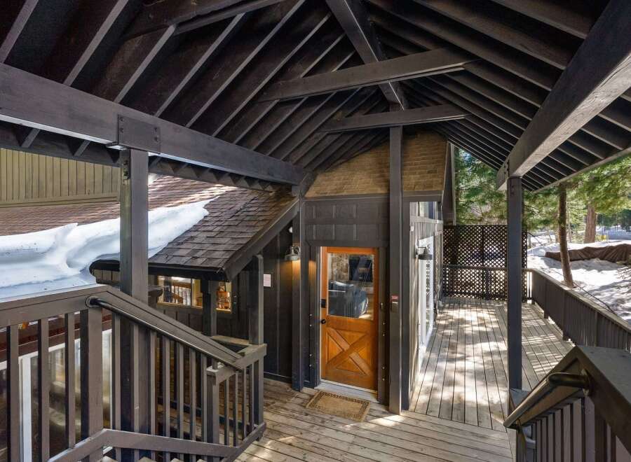 Discover the charm of this stunning property, featuring a beautifully designed wooden deck and an inviting entrance.