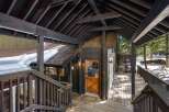 Discover the charm of this stunning property, featuring a beautifully designed wooden deck and an inviting entrance.