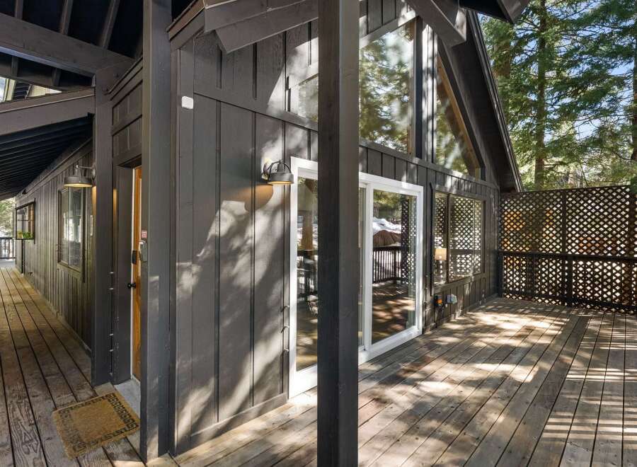 Discover the charm of this stunning property, featuring a beautifully designed exterior with a welcoming porch and deck.