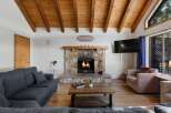 Cozy up in this charming living room, featuring a stunning stone fireplace and a warm, inviting atmosphere.