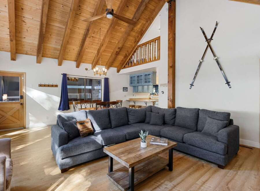 Discover the charm of this stunning property featuring a cozy living room with a large sectional sofa, perfect for gatherings.