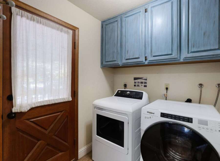 Step into the convenience of this well-appointed laundry room, featuring modern appliances and ample storage.