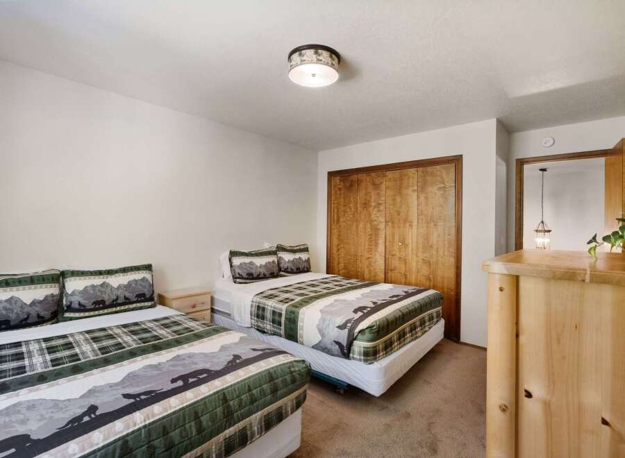 This cozy bedroom features two twin beds, perfect for guests or a shared living space.