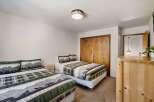 This cozy bedroom features two twin beds, perfect for guests or a shared living space.