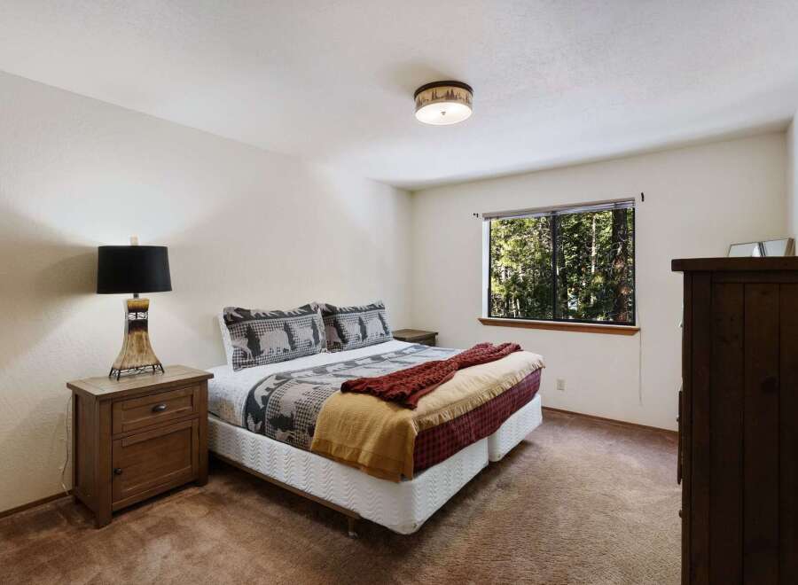 This cozy bedroom offers a serene retreat with its inviting ambiance and rustic charm.