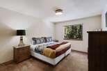 This cozy bedroom offers a serene retreat with its inviting ambiance and rustic charm.