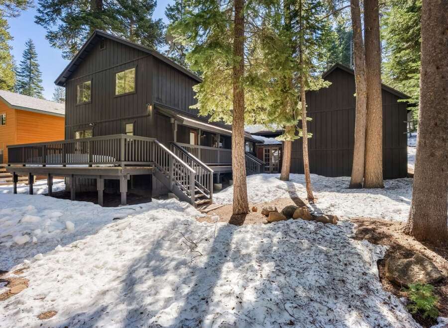 Nestled amidst towering trees, this stunning property offers a serene escape.
