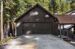 This stunning property boasts a charming exterior with a dark-colored garage door and a welcoming entrance.