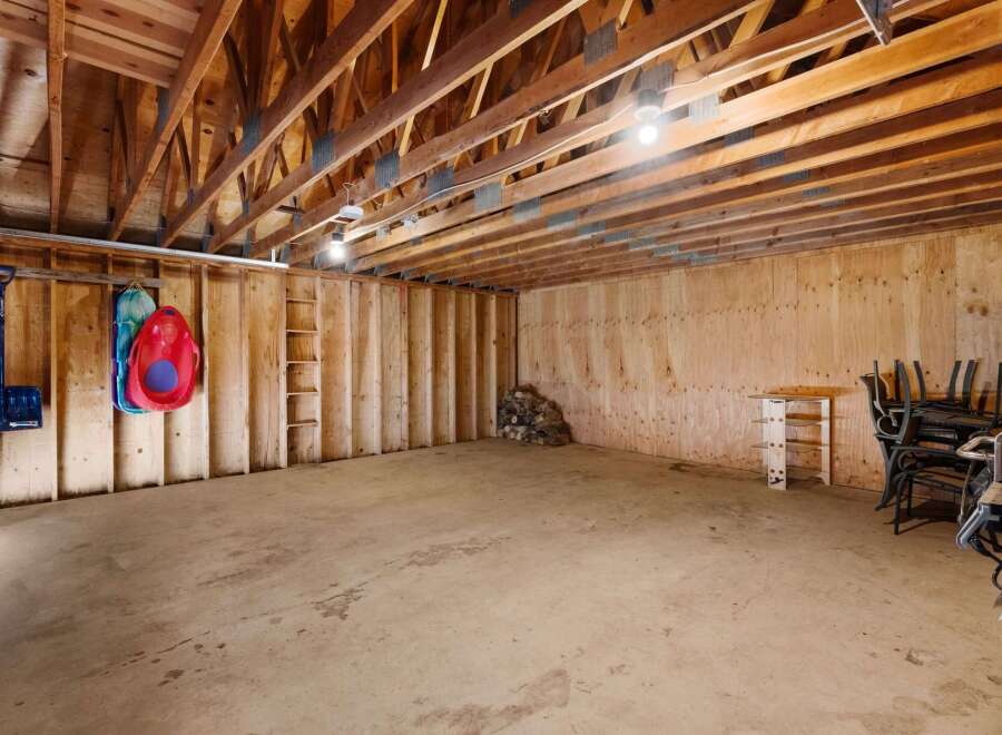 Discover the potential of this spacious property! This image showcases a large, open area with exposed wooden beams, perfect for customization.