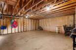 Discover the potential of this spacious property! This image showcases a large, open area with exposed wooden beams, perfect for customization.