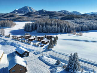 Discover your dream winter retreat in this stunning property nestled amidst a snow-covered landscape.