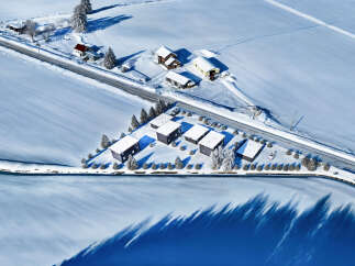 Discover a serene winter retreat in this stunning aerial view.