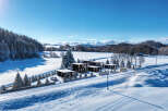 Discover a stunning winter retreat with modern homes nestled in a snowy landscape.