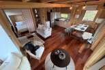 Step into this cozy cabin retreat, showcasing a warm and inviting interior with beautiful wooden floors and walls.