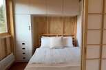 Discover the charm of this cozy bedroom, featuring a stylish built-in wardrobe and a comfortable bed.