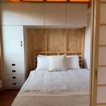 Discover the charm of this cozy bedroom, featuring a stylish built-in wardrobe and a comfortable bed.