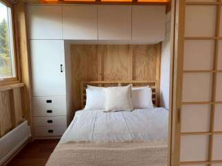 Discover the charm of this cozy bedroom, featuring a stylish built-in wardrobe and a comfortable bed.