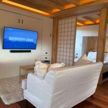 This cozy living space features a modern design with a built-in entertainment center and a comfortable sofa.