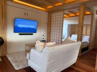 This cozy living space features a modern design with a built-in entertainment center and a comfortable sofa.