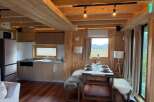 Step into this cozy cabin retreat, featuring a warm wooden interior and modern amenities.