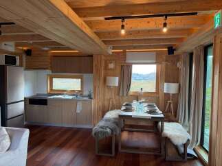 Step into this cozy cabin retreat, featuring a warm wooden interior and modern amenities.
