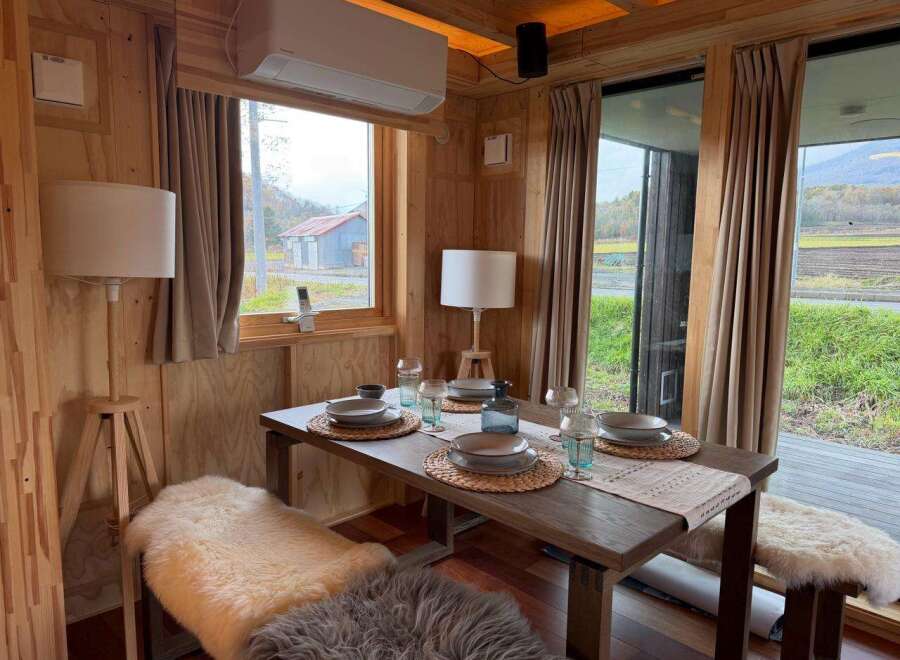Step into a cozy dining space with natural light and rustic charm.
