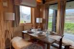 Step into a cozy dining space with natural light and rustic charm.