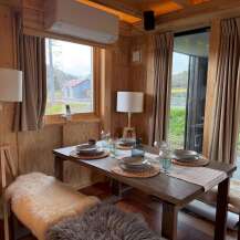Step into a cozy dining space with natural light and rustic charm.