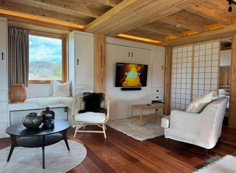 Step into this cozy retreat featuring a stylish living area with a modern TV setup and comfortable seating.