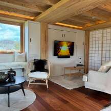 Step into this cozy retreat featuring a stylish living area with a modern TV setup and comfortable seating.