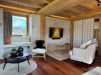 Step into this cozy retreat featuring a stylish living area with a modern TV setup and comfortable seating.