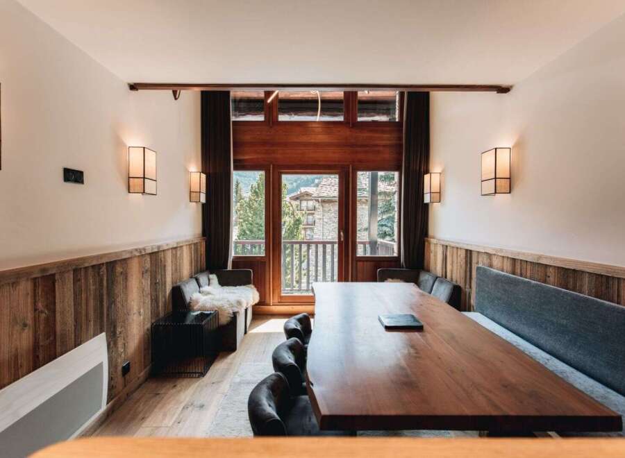 This stunning dining area features a large wooden table, perfect for gatherings.
