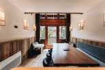 This stunning dining area features a large wooden table, perfect for gatherings.