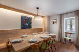 This stunning dining room features a large wooden table, perfect for hosting gatherings.