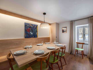 This stunning dining room features a large wooden table, perfect for hosting gatherings.