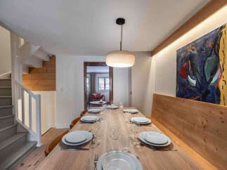 This stunning dining area showcases a beautifully crafted wooden table, perfect for hosting gatherings.