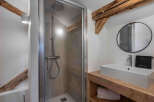 This charming bathroom features a modern shower and a stylish vanity.